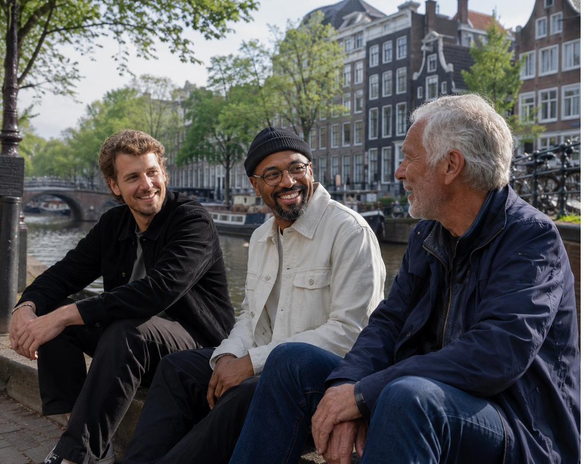 The Proud Company founders sitting by an Amsterdam canal with a guest